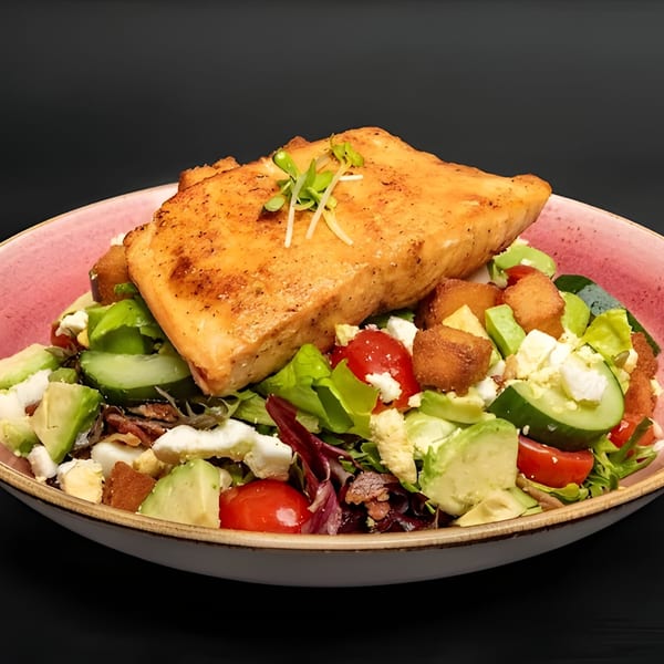 Just Brunch's salmon salad with mixed greens, avocado, cucumber, tomatoes, feta, and croutons.