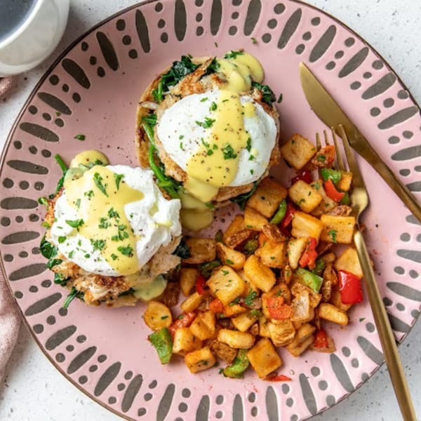 Just Brunch's Eggs Benedict with poached eggs, hollandaise, and a side of breakfast potatoes.
